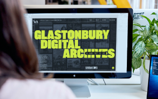 The Glastonbury Digital Archive shown on a iMac screen, over the shoulder