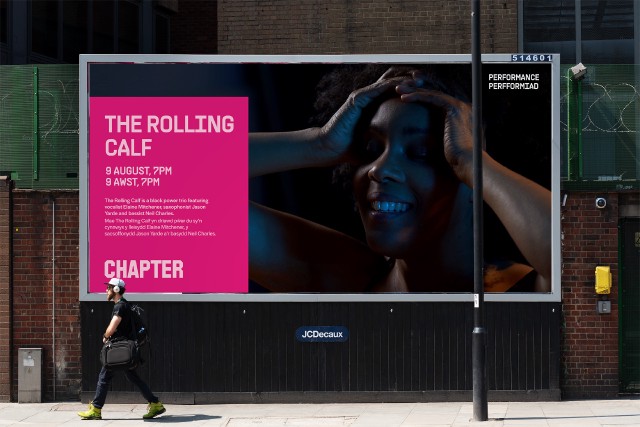 A mockup of a billboard for “The Rolling Calf” a performance event at Chapter. A man is walking past the billboard at the bottom left of the image.