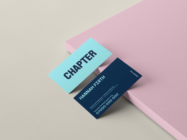 A mockup of a Chapter business card. The business card is duotone blue and is placed on a pink board