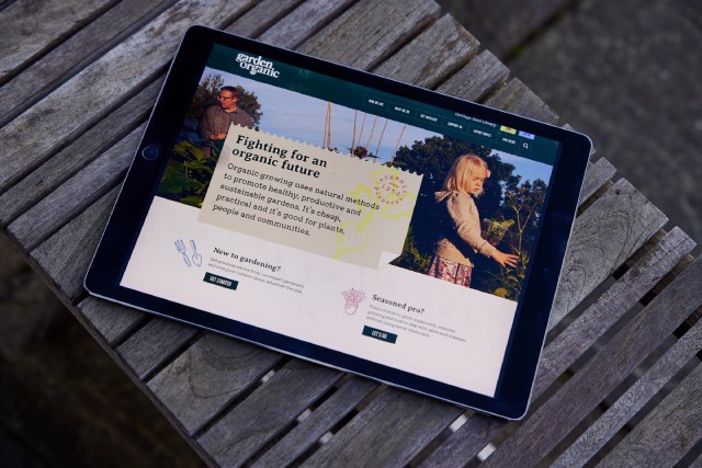The Garden Organic website on a tablet device, on a garden bench