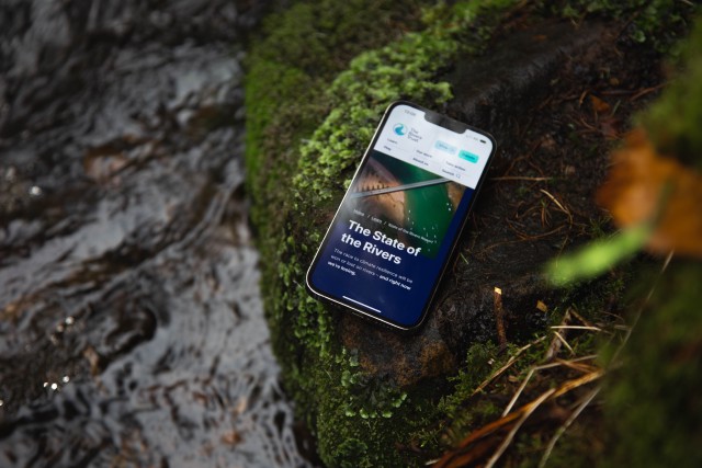 The Rivers Trust website on a mobile device, on a river bank
