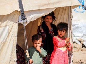 Three child refugees in a tent Kabul